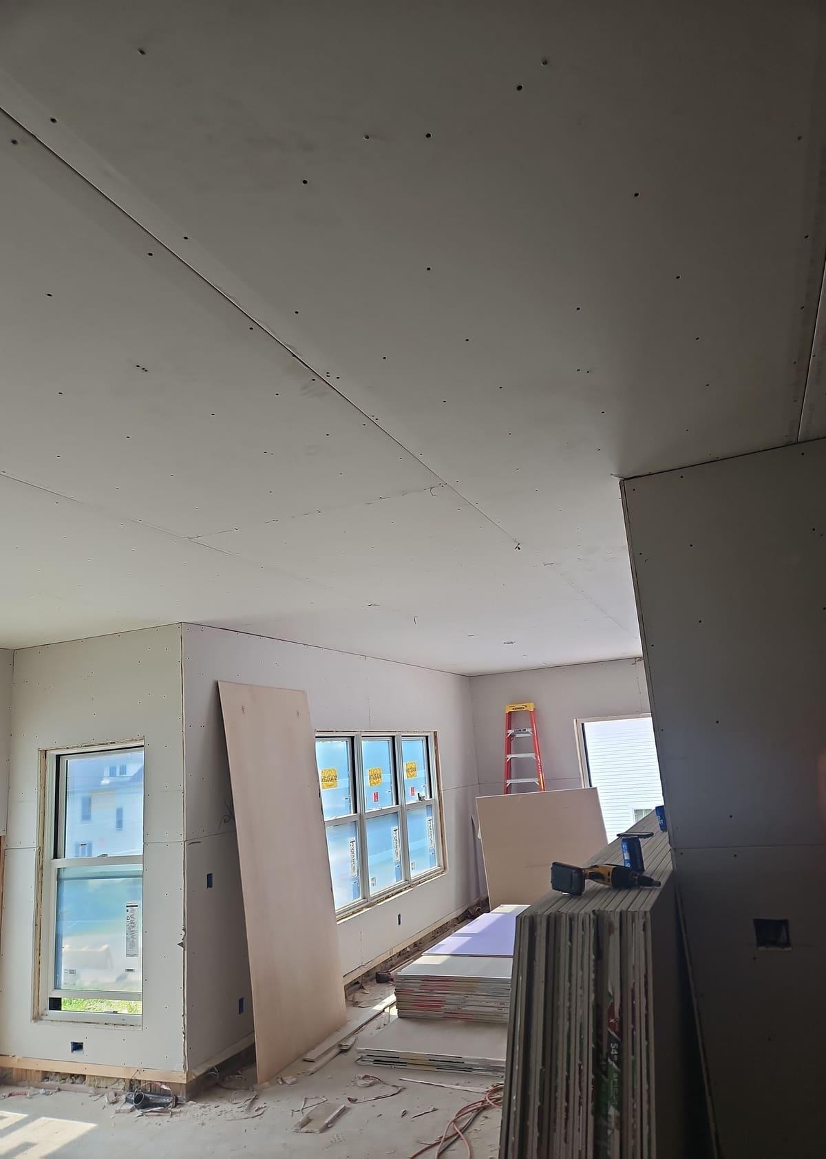 New construction room with walls and ceiling fully hung in drywall